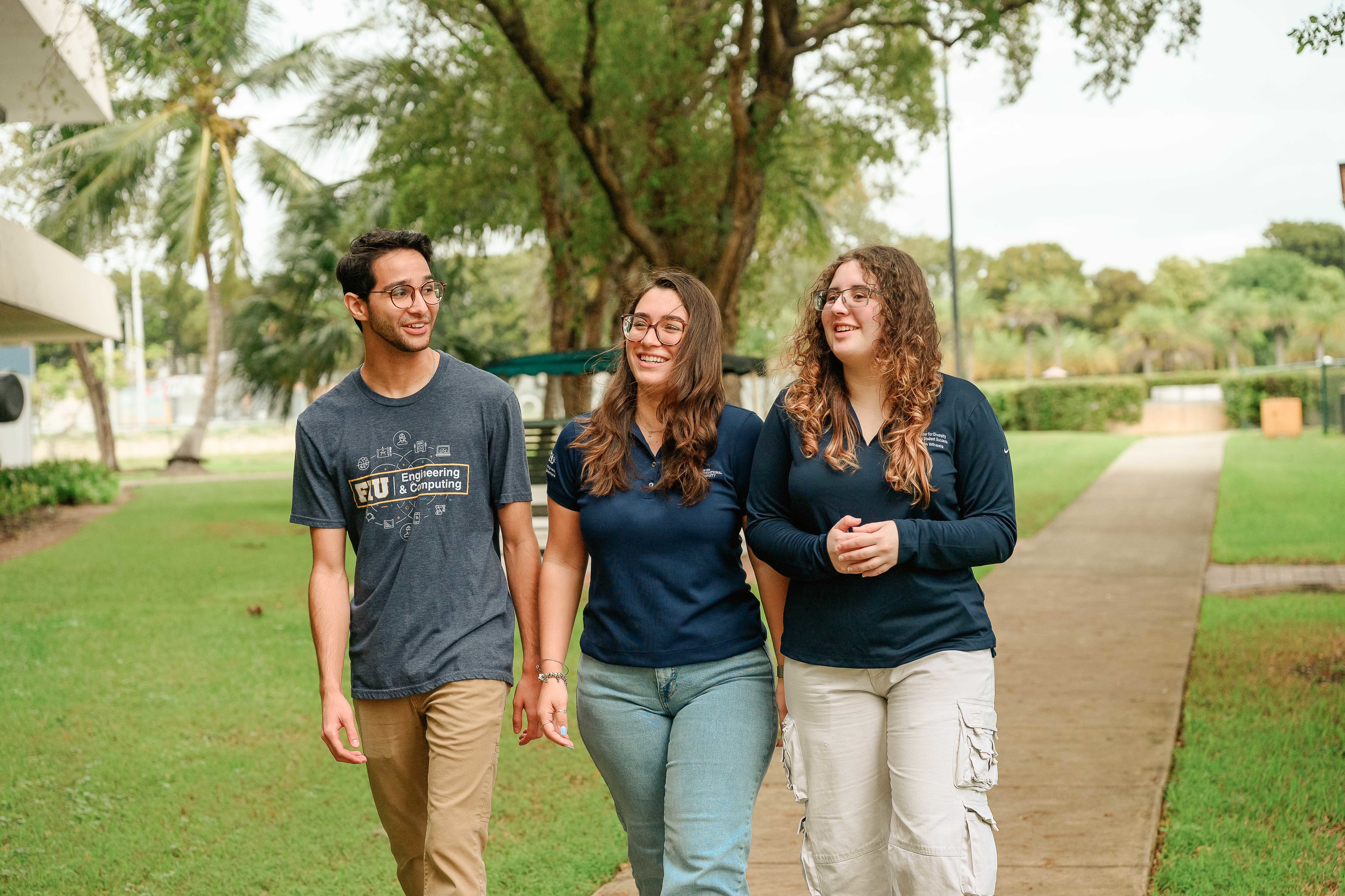 Three FIU students walking on campus.